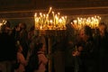 People light candles during festive prayer in church Royalty Free Stock Photo